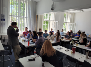 NAFAns in seated in a classroom at ESCP Business School, Berlin Campus listening to speaker