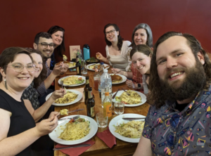 Eight NAFAns seated around a table at Spätzle club eating lunch