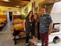 Three NAFAns, Lori, Elizabeth, and Dan, standing in front of tables at restaurant Heuriger Wolff 